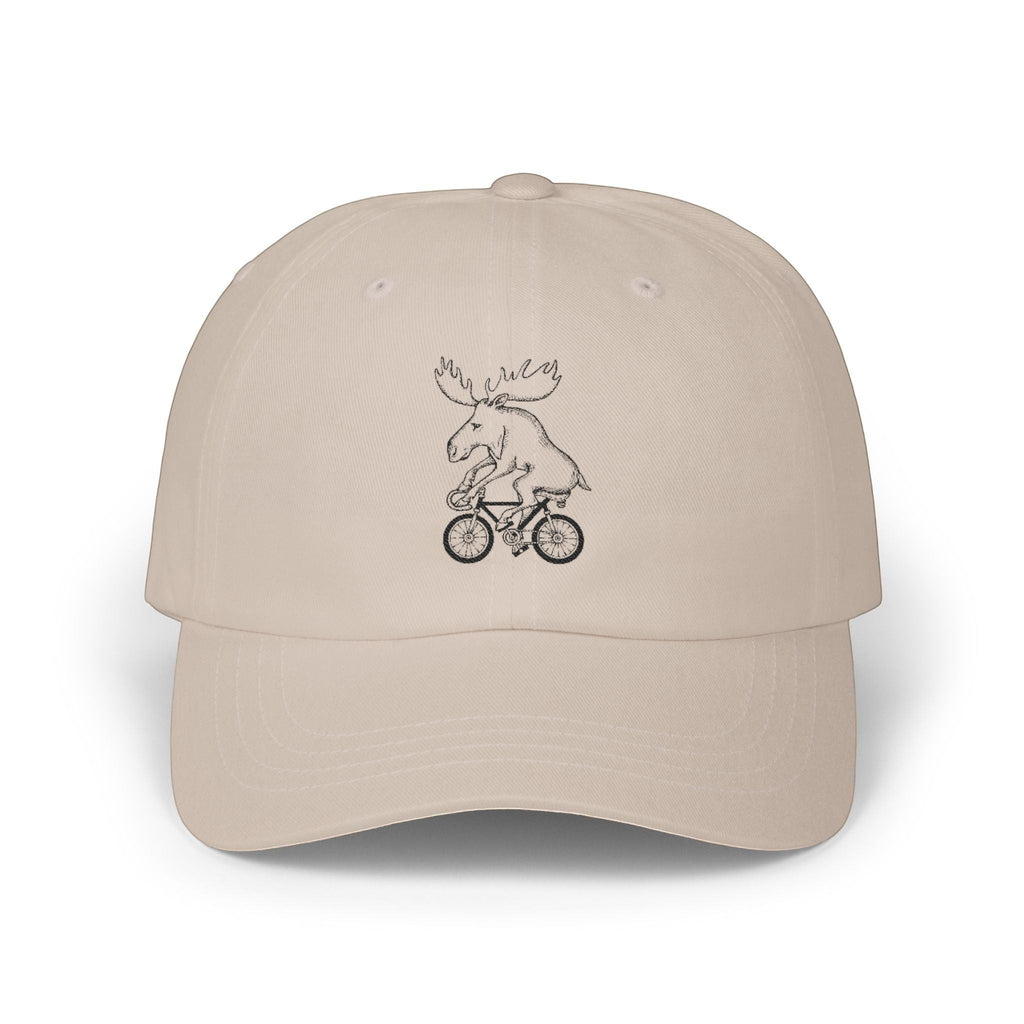 Rack & Cycle beige cotton dad cap with a whimsical embroidered moose riding a bicycle. Low-profile, casual outdoor baseball hat.