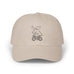 Rack & Cycle beige cotton dad cap with a whimsical embroidered moose riding a bicycle. Low-profile, casual outdoor baseball hat.