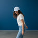 Rack & Cycle light blue cotton dad cap with embroidered moose on a bicycle, pre-curved visor, and adjustable strap.