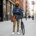 Rack & Cycle orange acrylic fisherman beanie with ribbed cuff and embroidered moose on a bike motif.