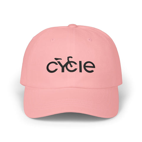 Rack & Cycle pink cotton dad cap with embroidered black 'CYCLE' text and bicycle silhouette. Adjustable strap.