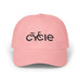 Rack & Cycle pink cotton dad cap with embroidered black 'CYCLE' text and bicycle silhouette. Adjustable strap.
