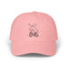 Rack & Cycle pink cotton dad cap with a whimsical moose riding a bicycle embroidered on the front.
